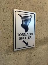 Tornado shelter sign pointing downstairs